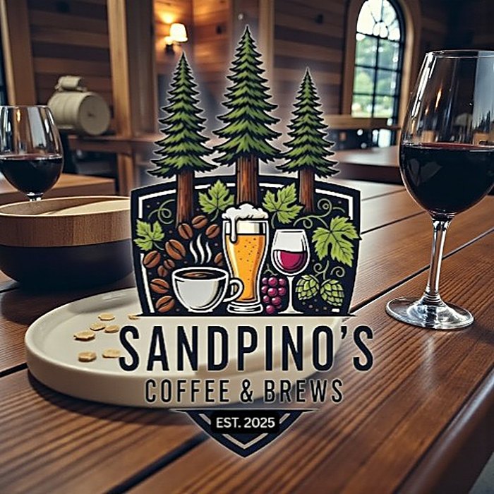 The Sandpino's Coffee and Brews logo over a warm wooden dining room set with glasses of red wine.